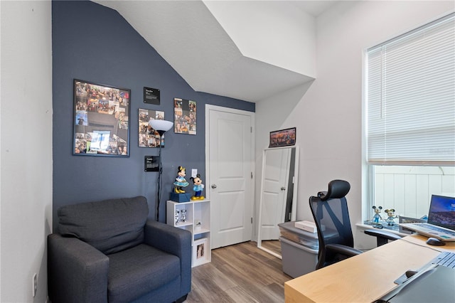 office area with vaulted ceiling and wood finished floors