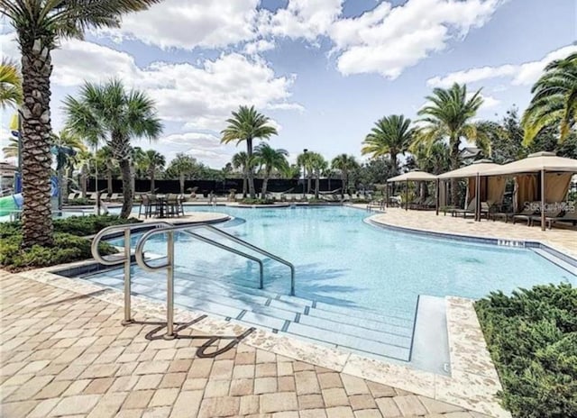 pool with a patio area and a gazebo