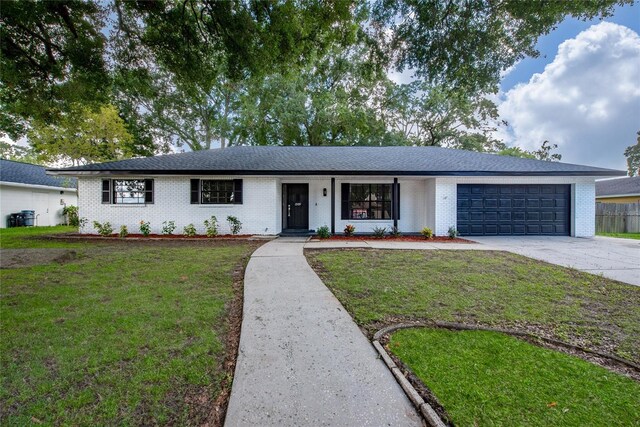 ranch-style home with a porch, a garage, and a front lawn