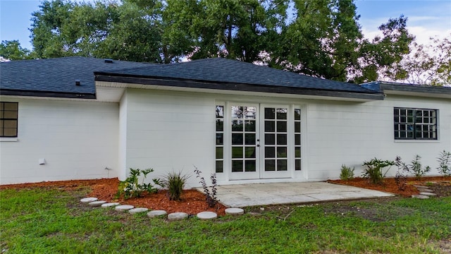 rear view of property with french doors, a yard, and a patio