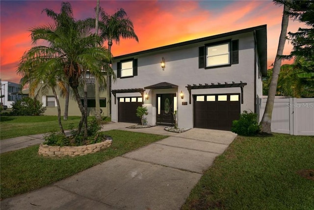 view of front of home featuring a garage and a lawn