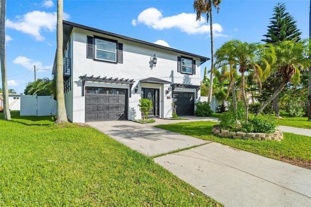 view of front of house with a garage and a front lawn