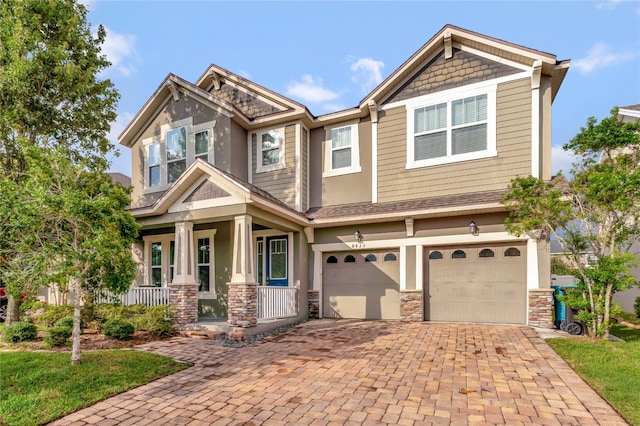 craftsman inspired home with a garage and a porch