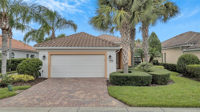 mediterranean / spanish house with a front yard and a garage