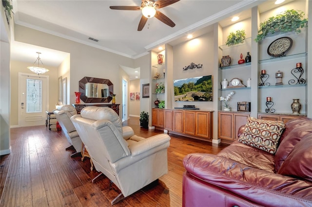 living room featuring ceiling fan, ornamental molding, wood-type flooring, and built in features