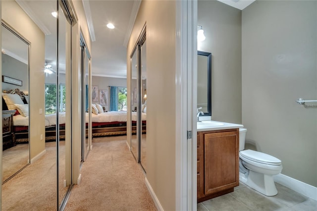 bathroom featuring ceiling fan, crown molding, toilet, and vanity