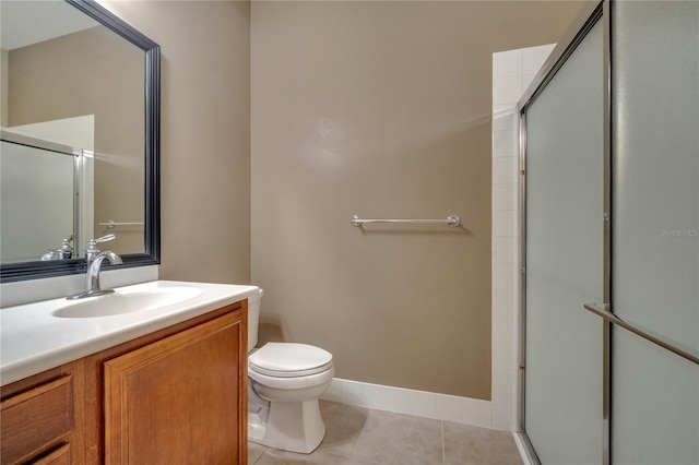 bathroom with an enclosed shower, toilet, vanity, and tile patterned floors