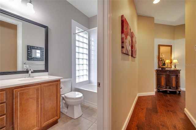 full bathroom featuring hardwood / wood-style floors, bathing tub / shower combination, toilet, and vanity