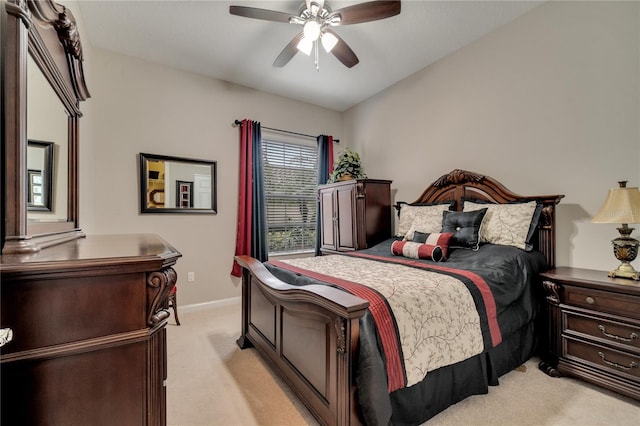 bedroom with ceiling fan and light carpet