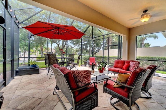 sunroom / solarium featuring ceiling fan