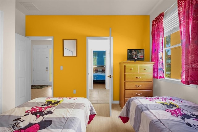 bedroom featuring light hardwood / wood-style flooring and multiple windows