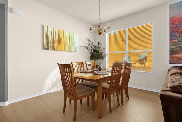 dining room featuring hardwood / wood-style flooring and a notable chandelier