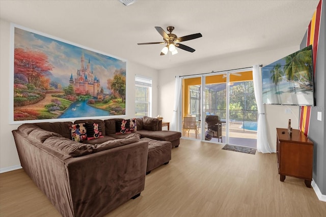 living room with light hardwood / wood-style floors and ceiling fan