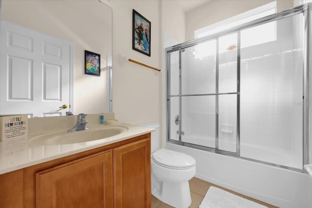 full bathroom featuring tile patterned floors, vanity, toilet, and enclosed tub / shower combo