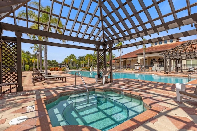 view of pool with a patio area and a hot tub