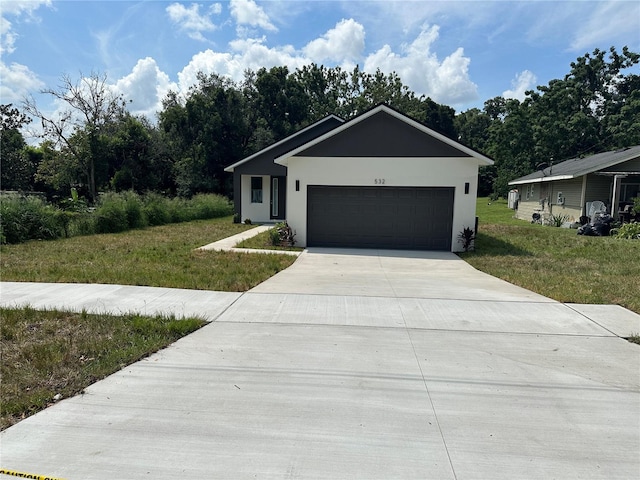 view of front of property featuring a garage and a front yard