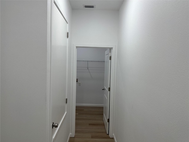 hallway with light wood-style floors and visible vents