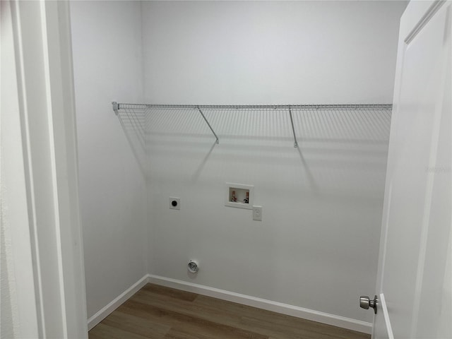 laundry area with washer hookup, hookup for an electric dryer, wood finished floors, laundry area, and baseboards