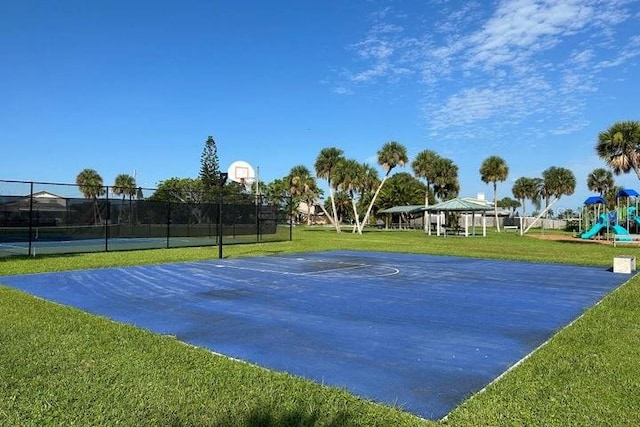 view of basketball court with a gazebo, a playground, and a lawn