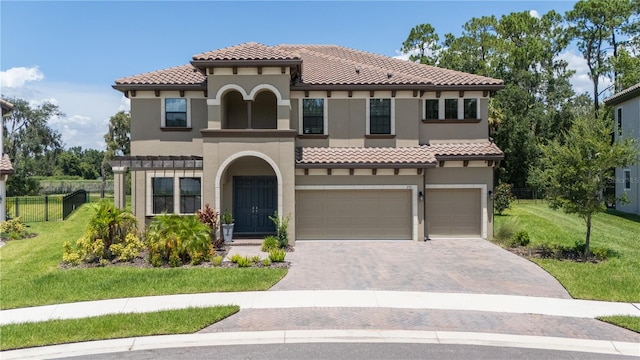 mediterranean / spanish house with a front yard and a garage