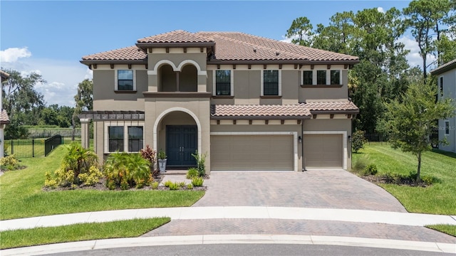 291 Mossy River Ct, Brandon, FL 33511 - mediterranean / spanish house featuring a tile roof, stucco siding, fence, an attached garage, and a front lawn