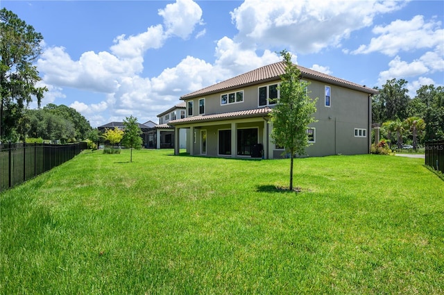 291 Mossy River Ct, Brandon, FL 33511 - rear view of property with a lawn, a tile roof, fence, and stucco siding