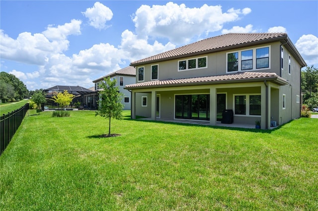 291 Mossy River Ct, Brandon, FL 33511 - rear view of property featuring a lawn, fence, a tiled roof, and stucco siding