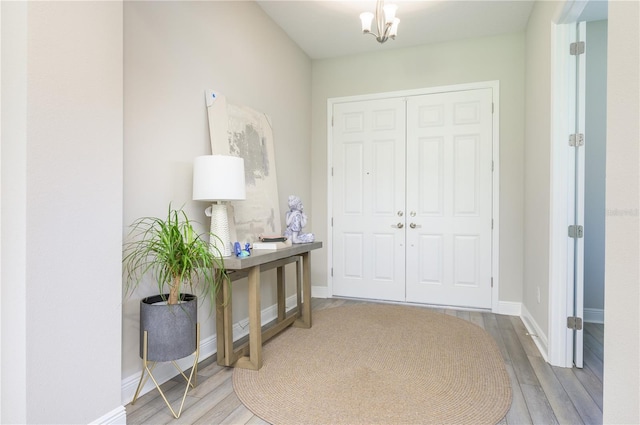 291 Mossy River Ct, Brandon, FL 33511 - entrance foyer with a notable chandelier, baseboards, and wood finished floors