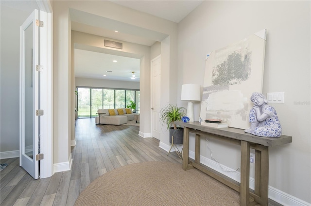 hall with hardwood / wood-style floors