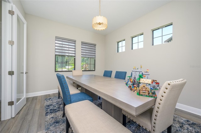 dining room featuring hardwood / wood-style floors and a chandelier