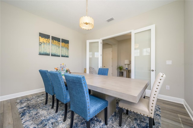 dining space with dark hardwood / wood-style flooring and french doors