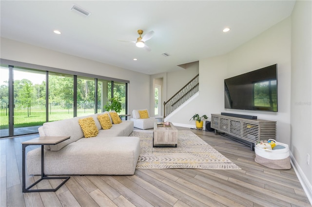 living room featuring ceiling fan and wood-type flooring