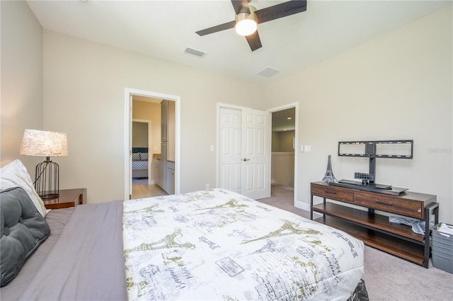 carpeted bedroom with ceiling fan and connected bathroom