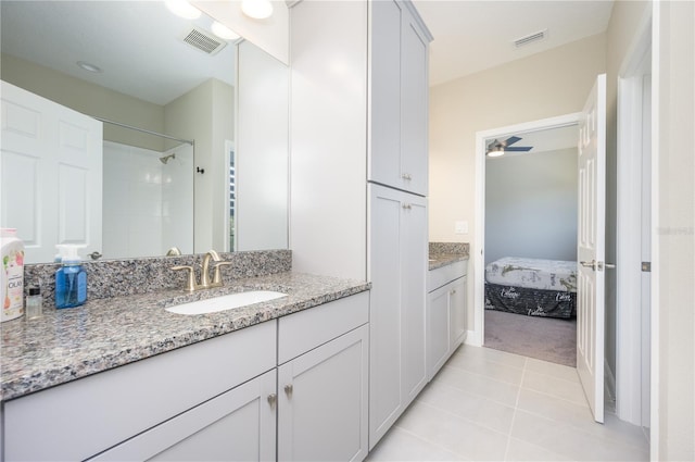 bathroom featuring tile patterned floors, vanity, and ceiling fan