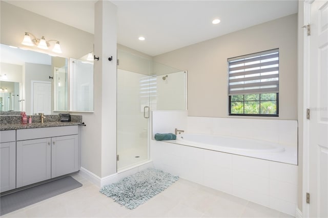 bathroom with shower with separate bathtub, vanity, and tile patterned floors