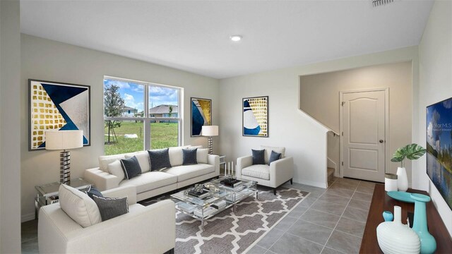 tiled living room featuring visible vents and baseboards