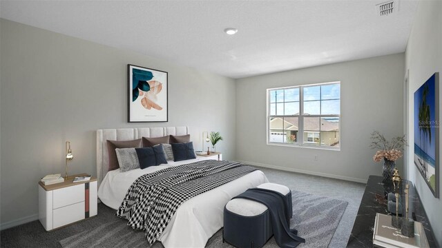 bedroom with dark colored carpet, visible vents, and baseboards