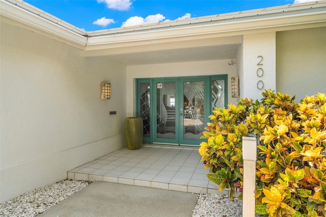 view of exterior entry featuring a patio and stucco siding