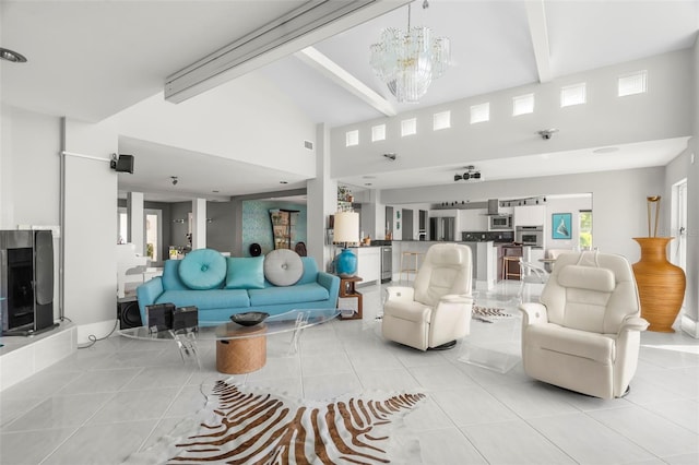 tiled living room with beam ceiling, a high ceiling, and a notable chandelier