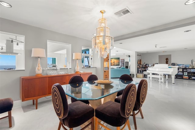 dining area featuring a notable chandelier and beamed ceiling