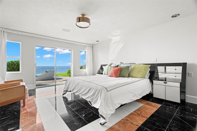 bedroom with baseboards, marble finish floor, a water view, and access to exterior