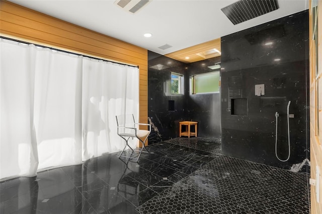 bathroom with wood walls and walk in shower