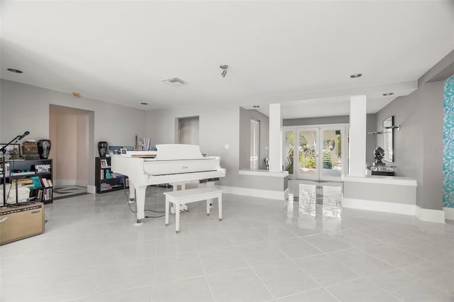 sitting room with french doors, visible vents, baseboards, and light tile patterned floors