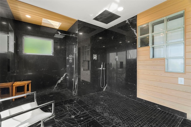 bathroom featuring tiled shower and wooden walls