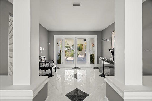 entryway featuring french doors and light tile patterned flooring