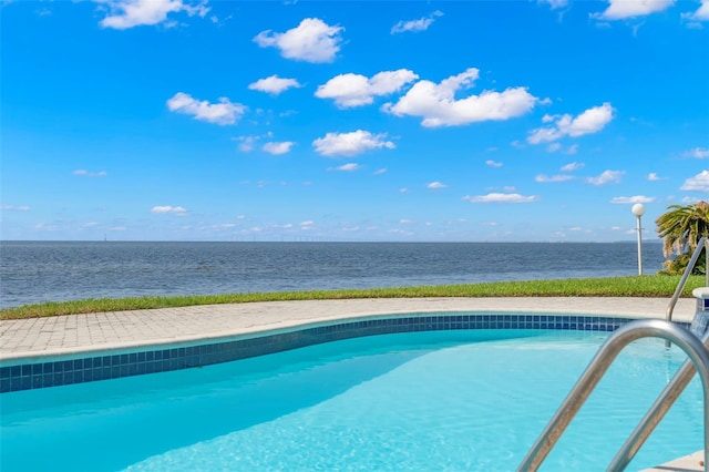 view of swimming pool with a water view