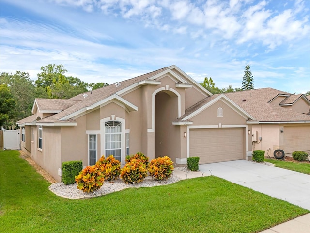 view of front facade featuring a garage and a front lawn