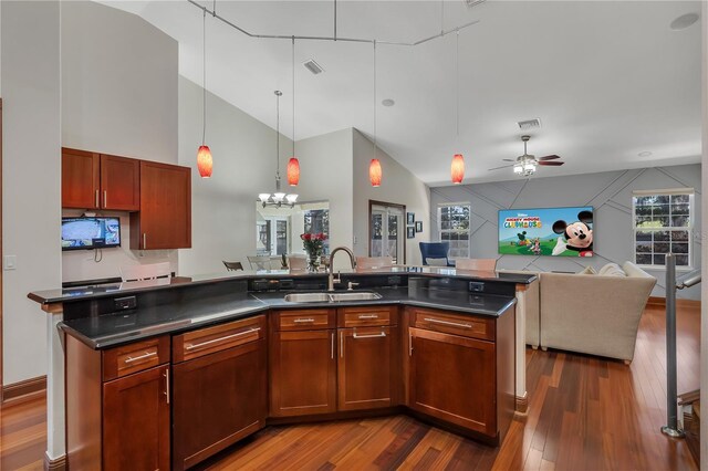 kitchen featuring sink, hanging light fixtures, ceiling fan with notable chandelier, and hardwood / wood-style floors