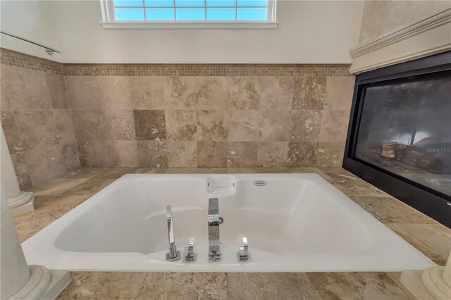 bathroom featuring tiled bath