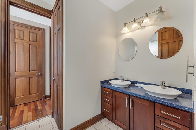 bathroom featuring double sink vanity and wood-type flooring